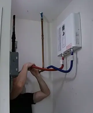Tankless water heater wall pipe installation and venting in Tustin California home